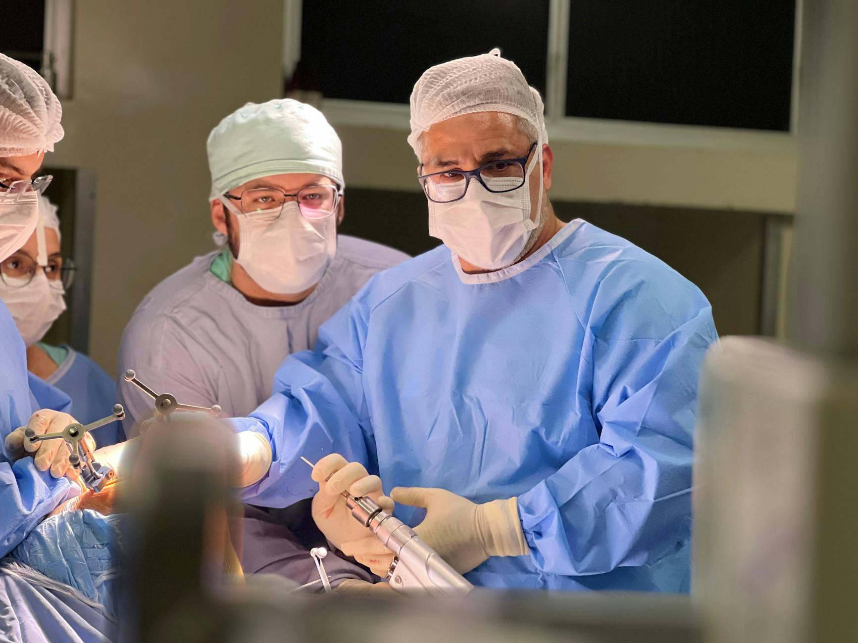 surgeons performing surgery in operating room